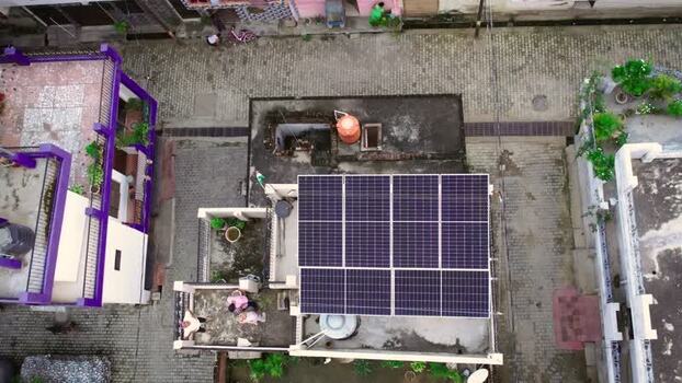 Aerial view of solar panels on a residential rooftop in India.
