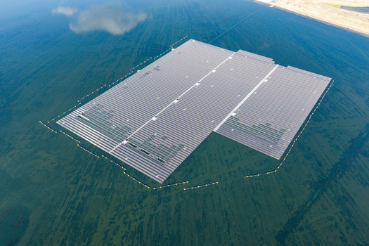 Aerial view of the floating solar park at Cottbuser Ostsee a former open pit mine with visible repair works on the panels Cottbus Brandenburg Germany. Aerial view of the floating solar park at Cottbuser Ostsee a former open pit mine with visible repair works on the panels Cottbus Brandenburg Germany.