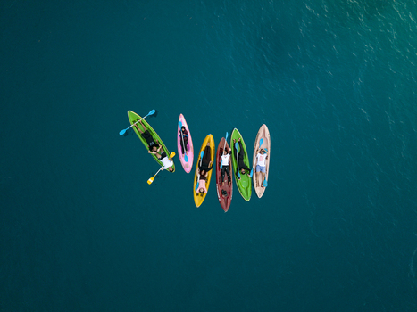 Aerial view of vibrant paddleboards cutting through the turquoise waters surrounding Menjangan Kecil Island creating a striking contrast of colors Karimunjawa Central Java Indonesia.