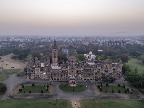 Vadodara India 14 March 2026 Aerial view of Laxmi Vilas Palace featuring its grand Indo Saracenic architecture ornate domes and tall tower surrounded by lush gardens and city skyline at dusk. Vadodara India 14 March 2026 Aerial view of Laxmi Vilas Palace featuring its grand Indo Saracenic architecture ornate domes and tall tower surrounded by lush gardens and city skyline at dusk.