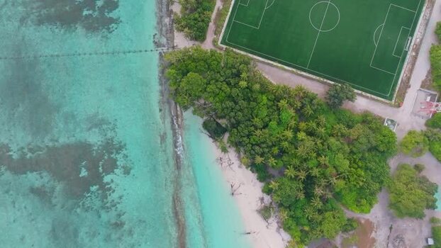 Aerial view of buildings and clear water Maldives.