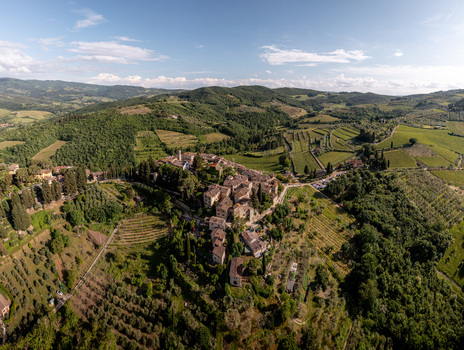 Aerial view of the historic village of Montefioralle surrounded by lush vineyards olive groves and rolling hills in the heart of the Tuscan countryside Montefioralle Tuscany Italy. Aerial view of the historic village of Montefioralle surrounded by lush vineyards olive groves and rolling hills in the heart of the Tuscan countryside Montefioralle Tuscany Italy.