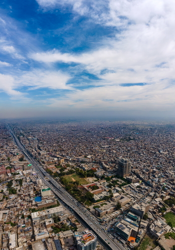 Aerial view of the historic Bala Hisar Fort surrounded by the dense urban landscape and bustling roads of Peshawar Khyber Pakhtunkhwa Pakistan.