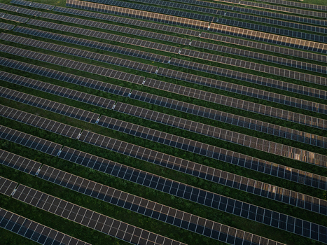 Aerial view of a large solar panel farm with long diagonal rows of photovoltaic modules installed on green grass Augusta Sicily Italy. Aerial view of a large solar panel farm with long diagonal rows of photovoltaic modules installed on green grass Augusta Sicily Italy.