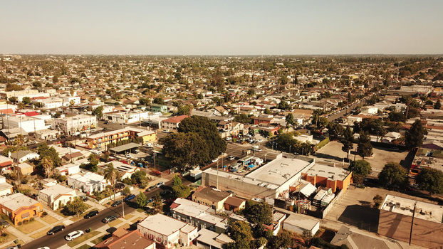Aerial view of a sprawling residential neighborhood with dense housing streets and trees in Los Angeles California United States. Aerial view of a sprawling residential neighborhood with dense housing streets and trees in Los Angeles California United States.