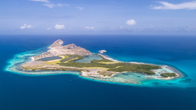 Aerial view of Los Roques archipelago featuring turquoise waters coral reefs and sandy beaches in Los Roques Dependencias Federales Venezuela. Aerial view of Los Roques archipelago featuring turquoise waters coral reefs and sandy beaches in Los Roques Dependencias Federales Venezuela.