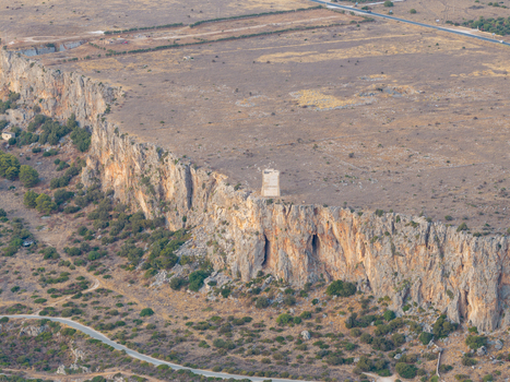 Aerial view of Riserva Naturale Orientata dello Zingaro featuring rugged limestone cliffs a historic watchtower and Mediterranean scrubland in San Vito Lo Capo Sicilia Italy. Aerial view of Riserva Naturale Orientata dello Zingaro featuring rugged limestone cliffs a historic watchtower and Mediterranean scrubland in San Vito Lo Capo Sicilia Italy.