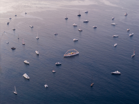 Aerial view of numerous luxury yachts and sailboats anchored in the calm blue waters of the Mediterranean Sea off the coast of Cannes Provence Alpes Cote d Azur France. Aerial view of numerous luxury yachts and sailboats anchored in the calm blue waters of the Mediterranean Sea off the coast of Cannes Provence Alpes Cote d Azur France.
