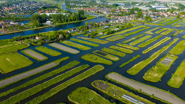 Aerial view of the Oosterdel nature reserve featuring a unique network of small islands and narrow canals in Broek op Langedijk Noord Holland Netherlands. Aerial view of the Oosterdel nature reserve featuring a unique network of small islands and narrow canals in Broek op Langedijk Noord Holland Netherlands.