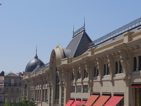 View of the historic Mercado do Bolhao with its neoclassical architecture prominent dome and orange awnings under a clear blue sky in Porto Porto District Portugal. View of the historic Mercado do Bolhao with its neoclassical architecture prominent dome and orange awnings under a clear blue sky in Porto Porto District Portugal.