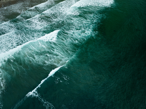 Aerial view of powerful ocean waves crashing with white foam against the shoreline of La Jolla Cove in San Diego California United States. Aerial view of powerful ocean waves crashing with white foam against the shoreline of La Jolla Cove in San Diego California United States.
