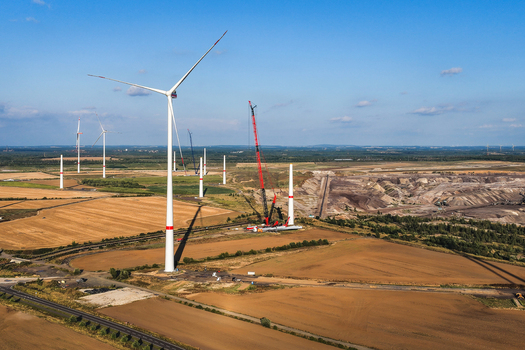 Aerial view of wind turbines under construction with a large crane at the lignite open cast mine Schleenhain in Zwenkau Saxony Germany.