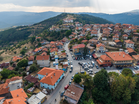 Aerial view of the village of Sveta Petka featuring a mosque with a minaret traditional houses with red tiled roofs winding roads and surrounding hills in Sveta Petka Pazardzhik Bulgaria. Aerial view of the village of Sveta Petka featuring a mosque with a minaret traditional houses with red tiled roofs winding roads and surrounding hills in Sveta Petka Pazardzhik Bulgaria.