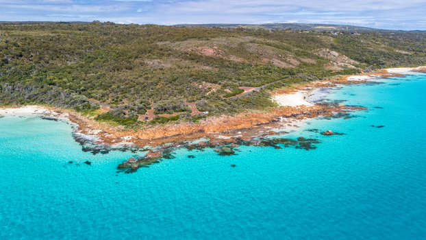 Aerial view of where the turquoise waters meet the rugged coastline a symphony of natural beauty unfolds Dunsborough Australia.