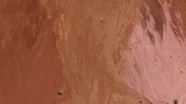 Aerial view of the arid red desert landscape with intricate erosion patterns and sparse vegetation in Australia. Aerial view of the arid red desert landscape with intricate erosion patterns and sparse vegetation in Australia.