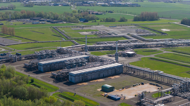 Aerial view of the NAM Grijpskerk UGS facility featuring industrial pipelines and storage infrastructure surrounded by green fields in Grijpskerk Groningen Netherlands.