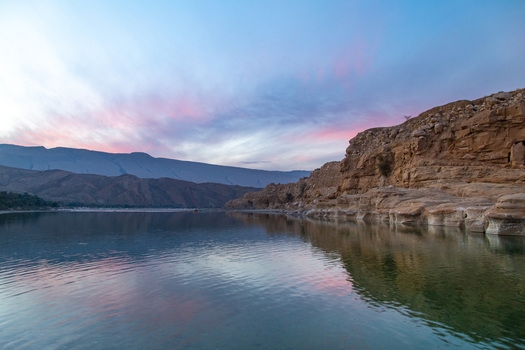 Aerial view of the serene lake mirroring the pastel streaked sky and the rugged sun kissed cliffs Pakistan. Aerial view of the serene lake mirroring the pastel streaked sky and the rugged sun kissed cliffs Pakistan.