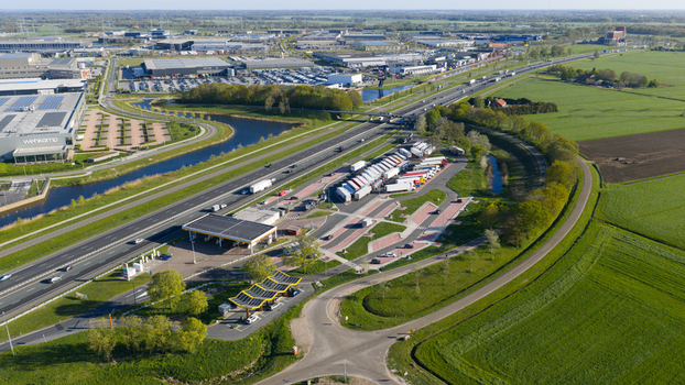 Zwolle Netherlands 23 April 2026 Aerial view of Fastned Charging Station and a highway rest area with parked trucks next to the A28 motorway surrounded by green fields. Zwolle Netherlands 23 April 2026 Aerial view of Fastned Charging Station and a highway rest area with parked trucks next to the A28 motorway surrounded by green fields.