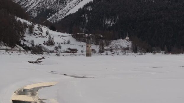 Aerial view of the historic bell tower in a frozen lake Italy. Aerial view of the historic bell tower in a frozen lake Italy.