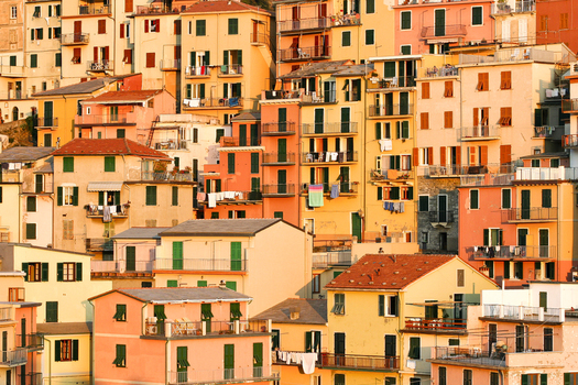 View of colorful historic houses of Manarola village stacked on the hillside during golden hour in Manarola Liguria Italy. View of colorful historic houses of Manarola village stacked on the hillside during golden hour in Manarola Liguria Italy.