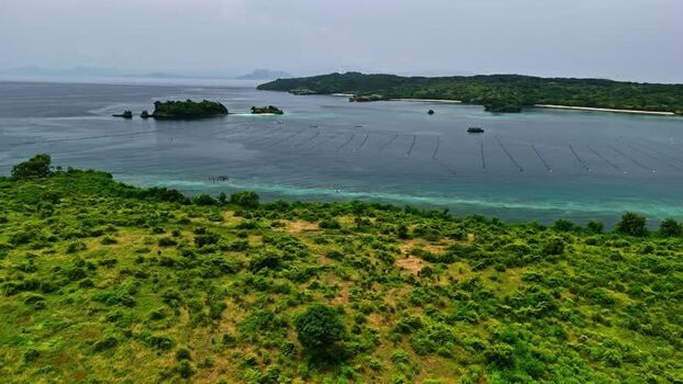 Aerial view of a coastal bay with seaweed farming in Bali Indonesia.