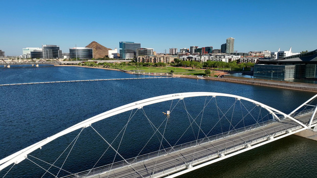 Aerial view of the Tempe Town Lake pedestrian bridge with the Tempe skyline and A Mountain in the background in Tempe Arizona United States. Aerial view of the Tempe Town Lake pedestrian bridge with the Tempe skyline and A Mountain in the background in Tempe Arizona United States.