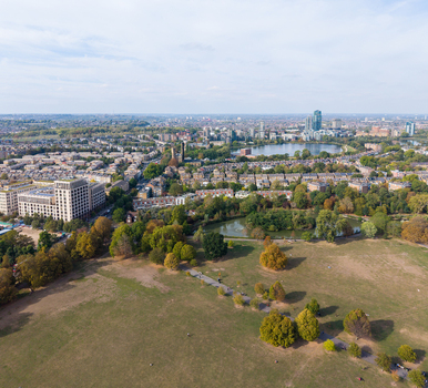 Aerial view of Clissold Park in Stoke Newington featuring a lake lush trees and surrounding residential architecture in London England United Kingdom. Aerial view of Clissold Park in Stoke Newington featuring a lake lush trees and surrounding residential architecture in London England United Kingdom.
