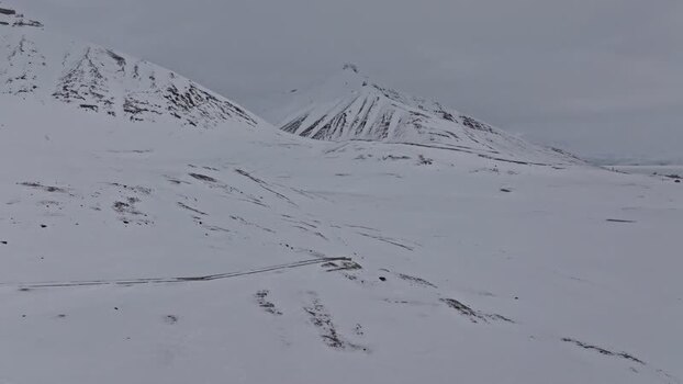 Aerial view of snow covered mountains in Pyramiden Svalbard and Jan Mayen.