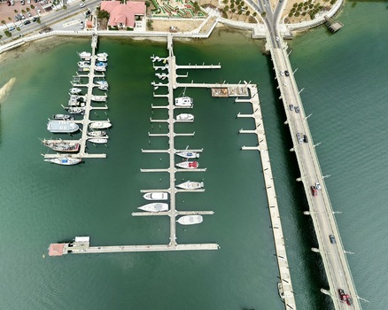 Aerial view of the marina with boats docked at piers next to the Bridge of Lions and waterfront buildings St. Augustine Florida United States.