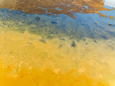 Aerial view of geothermal water with vibrant blue and yellow mineral deposits in Reykjanesbaer Iceland. Aerial view of geothermal water with vibrant blue and yellow mineral deposits in Reykjanesbaer Iceland.