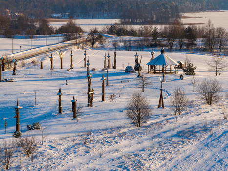 Aerial view of the Hill of Angels featuring wooden sculptures and a gazebo in a snow covered winter landscape in Traku rajonas Vilniaus apskritis Lithuania. Aerial view of the Hill of Angels featuring wooden sculptures and a gazebo in a snow covered winter landscape in Traku rajonas Vilniaus apskritis Lithuania.