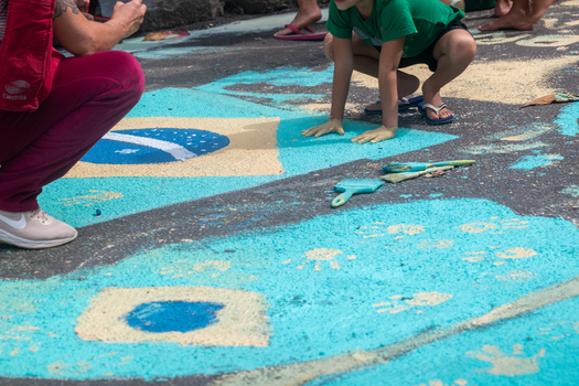 Rio de Janeiro Brazil 13 June 2026 View of people decorating a street with colorful sand and paint depicting the Brazilian flag for the World Cup 2026.