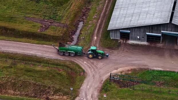 Aerial view of tractor with slurry tanker in Latvia. Aerial view of tractor with slurry tanker in Latvia.