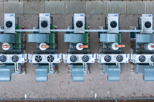 Aerial view of industrial HVAC cooling units arranged in a row on a gravel surface in Nasedlovice South Moravian Region Czechia.