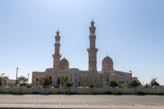 View of the Mohammed Al Ameen Mosque with its prominent domes and minarets under a clear blue sky in Muscat Muscat Governorate Oman. View of the Mohammed Al Ameen Mosque with its prominent domes and minarets under a clear blue sky in Muscat Muscat Governorate Oman.