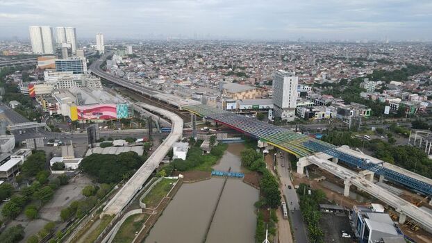 Bekasi Barat West Java Indonesia 06 February 2022 Aerial view of the elevated toll road construction project spanning over a river and dense urban landscape. Bekasi Barat West Java Indonesia 06 February 2022 Aerial view of the elevated toll road construction project spanning over a river and dense urban landscape.