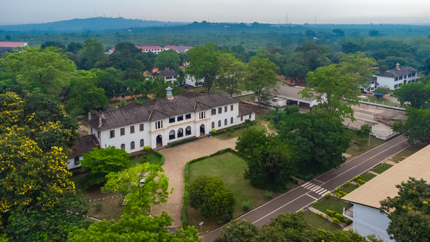 Aerial view of the historic Achimota School campus featuring white colonial style buildings surrounded by lush green trees and manicured lawns in Achimota Greater Accra Region Ghana. Aerial view of the historic Achimota School campus featuring white colonial style buildings surrounded by lush green trees and manicured lawns in Achimota Greater Accra Region Ghana.