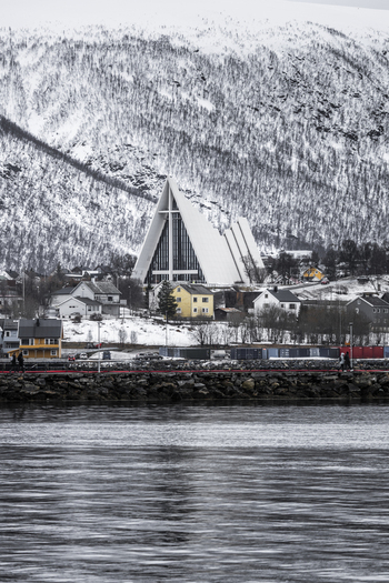 Tromso Norway 11 March 2026 View of the Arctic Cathedral with its iconic triangular architecture set against snow covered mountains and the waterfront. Tromso Norway 11 March 2026 View of the Arctic Cathedral with its iconic triangular architecture set against snow covered mountains and the waterfront.