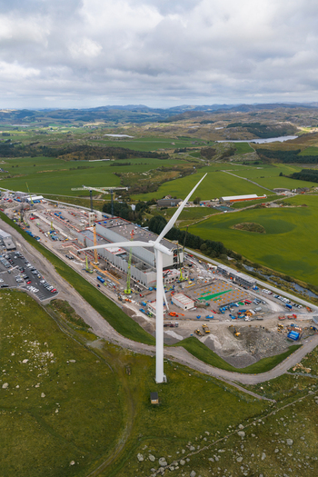Aerial view of the Green Mountain SVG Undheim data center construction site with a wind turbine cranes and industrial structures set amidst rolling green hills in Undheim Rogaland Norway. Aerial view of the Green Mountain SVG Undheim data center construction site with a wind turbine cranes and industrial structures set amidst rolling green hills in Undheim Rogaland Norway.