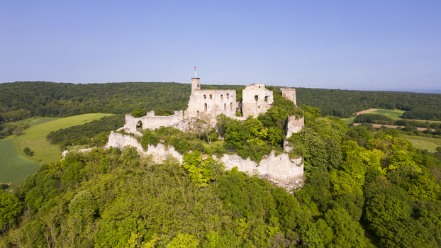Aerial view of the ancient castle ruins atop a verdant hill its weathered stones standing in stark contrast to the lush green landscape Falkenstein Lower Austria Austria. Aerial view of the ancient castle ruins atop a verdant hill its weathered stones standing in stark contrast to the lush green landscape Falkenstein Lower Austria Austria.
