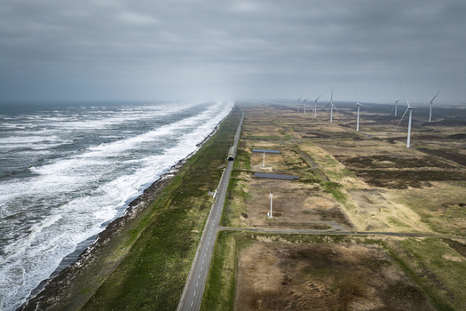 Aerial view of wind turbines along the rugged coastline and road in Wakkanai Hokkaido Japan.