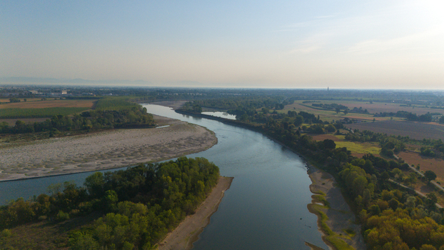 Aerial view of the Po River with low water levels and exposed sediment beaches caused by drought surrounded by agricultural fields in Castelvetro Piacentino Emilia Romagna Italy. Aerial view of the Po River with low water levels and exposed sediment beaches caused by drought surrounded by agricultural fields in Castelvetro Piacentino Emilia Romagna Italy.