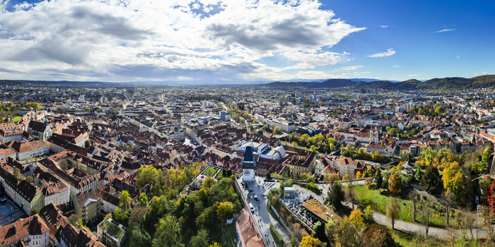 Aerial view of the terracotta rooftops contrasting with the modern architecture near the Schlossberg hill Graz Styria Austria.