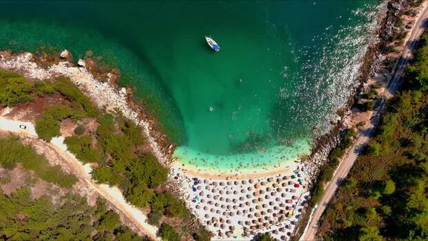 Aerial view of a beach with a boat in Thasos Greece.
