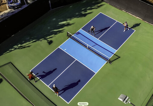 Valencia California United States 22 September 2026 Aerial view of four people playing pickleball on a court with long shadows cast across the green and blue surface. Valencia California United States 22 September 2026 Aerial view of four people playing pickleball on a court with long shadows cast across the green and blue surface.