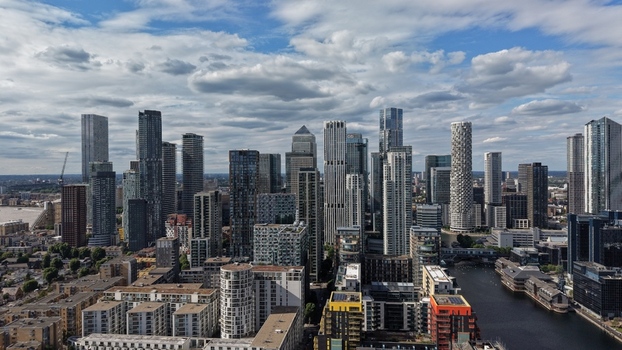 London United Kingdom 16 June 2026 Aerial view of the Canary Wharf skyline featuring modern skyscrapers residential buildings and the docks under a cloudy sky.