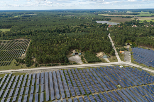Aerial view of the former Preschen military airfield now a solar power plant with historic hangars forest and remnants of the old runway in Neisse Malxetal Brandenburg Germany. Aerial view of the former Preschen military airfield now a solar power plant with historic hangars forest and remnants of the old runway in Neisse Malxetal Brandenburg Germany.