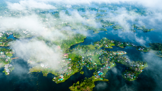 Rangamati Bangladesh 19 October 2022 Aerial view of the islands and lush green hills of Kaptai Lake in Rangamati Bangladesh partially obscured by low hanging clouds.