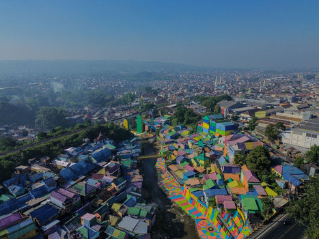 Aerial view of Kampung Warna Warni Jodipan with its brightly painted houses and colorful rooftops along the river in the urban landscape of Kecamatan Blimbing Jawa Timur Indonesia. Aerial view of Kampung Warna Warni Jodipan with its brightly painted houses and colorful rooftops along the river in the urban landscape of Kecamatan Blimbing Jawa Timur Indonesia.