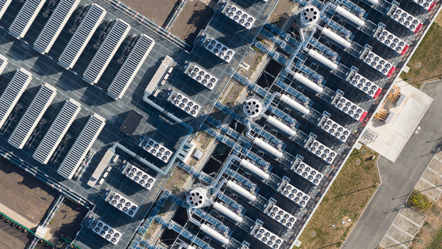 Aerial view of an industrial facility with rows of cooling units complex piping systems and technical infrastructure in Dietzenbach Hessen Germany. Aerial view of an industrial facility with rows of cooling units complex piping systems and technical infrastructure in Dietzenbach Hessen Germany.